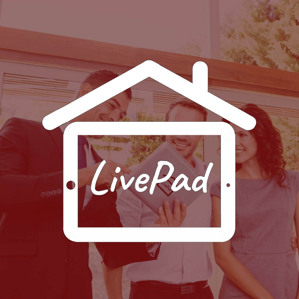 A group of people standing in front of a house with the livepad logo.